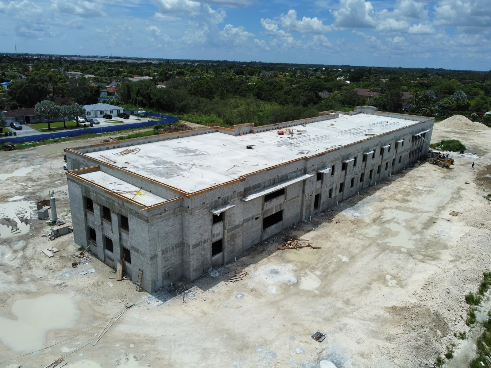 SW 216th Street campus in August 2023, with its two-story masonry shell and roof in place